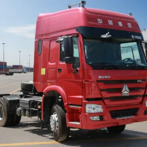 Sinotruk HOWO 4x2 tractor head, red cab, at a freight logistics depot