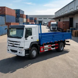Sinotruk HOWO 4x2 cargo truck, 6 wheels, white cab and blue drop-side body, at a logistics depot