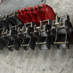 Semi-trailer suspension spring hangers and equalizer brackets, black and red, in the workshop