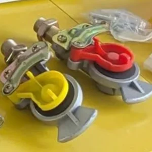 Red and yellow trailer palm couplings (gladhands) with brass fittings and dust caps