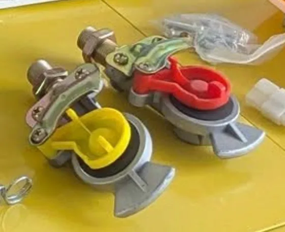 Red and yellow trailer palm couplings (gladhands) with brass fittings and dust caps
